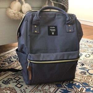 Top open backpack with gold hardware